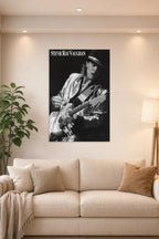 Stevie Ray Vaughan in a bright living room above a beige sofa.