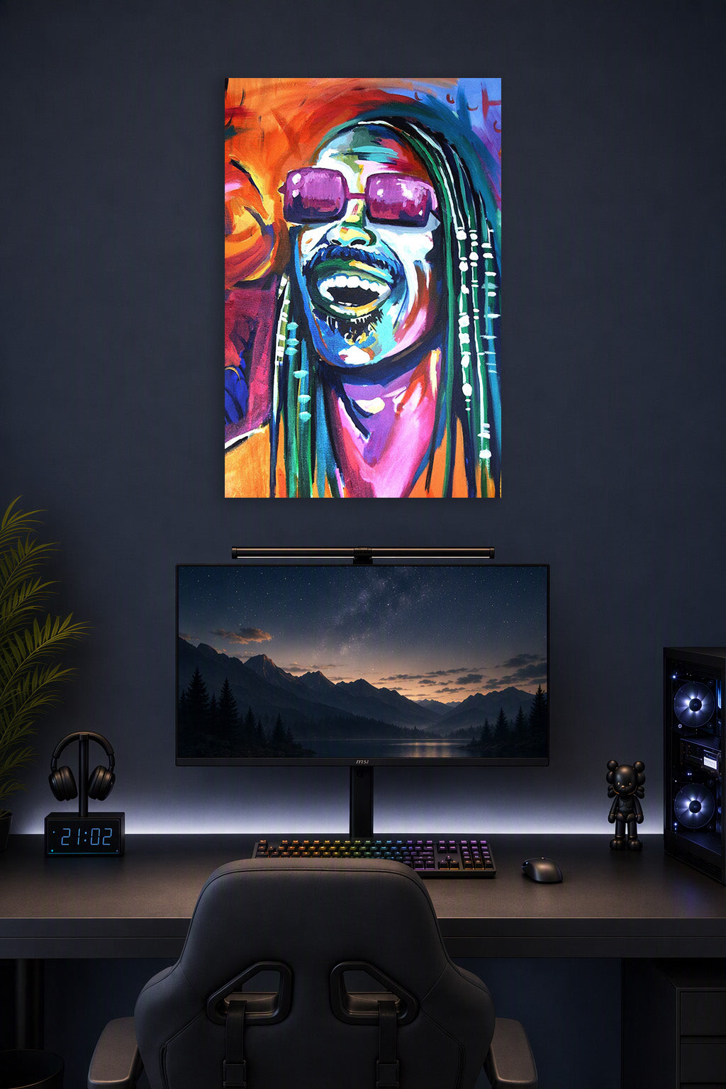 Stevie Wonder in a gaming desk setup above a monitor.