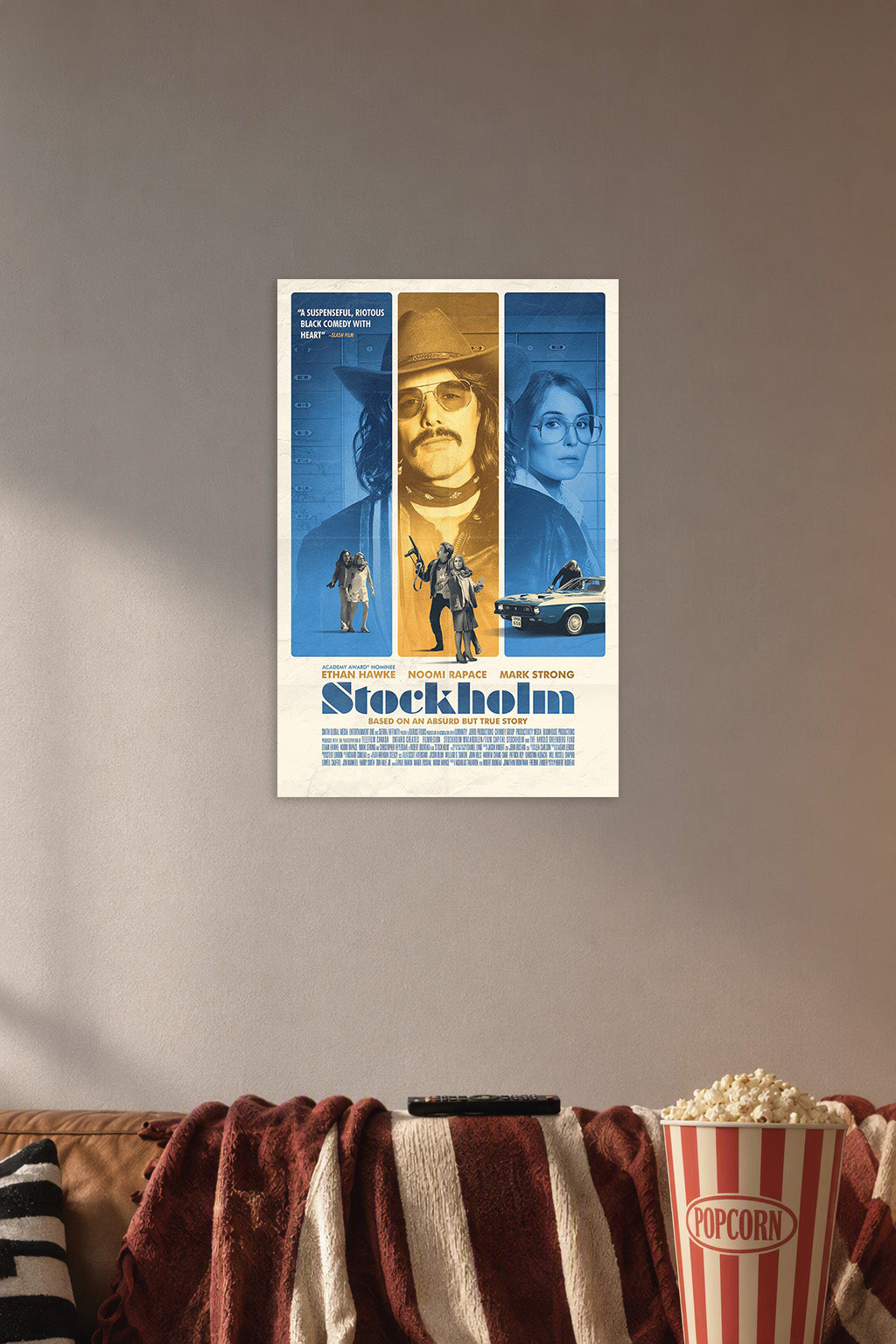 Stockholm Movie Poster in a cozy movie room above a brown sofa with popcorn.
