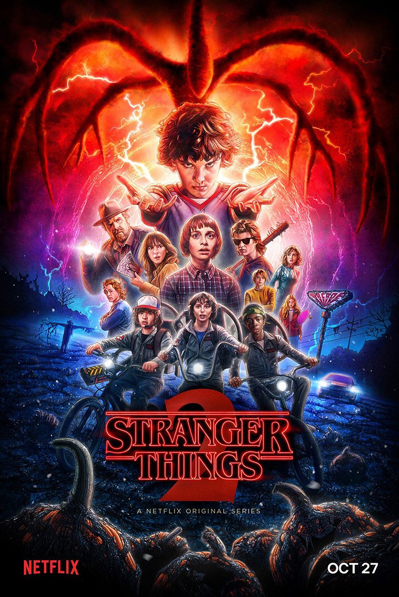 Stranger Things 2 poster features Eleven with raised hands, the Hawkins cast on bikes, red lightning, and a looming shadow monster.