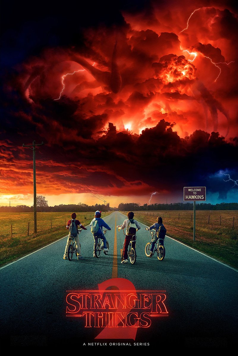 Stranger Things 2 wall art print depicts four boys on bicycles beneath a red lightning storm and a Welcome to Hawkins sign.