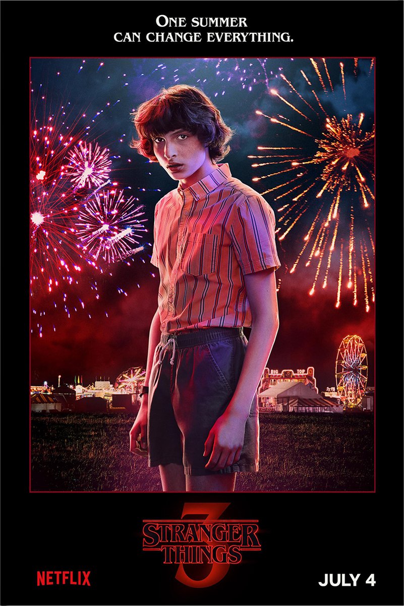 Mike Wheeler Stranger Things 3 poster features the boy in a striped shirt before vivid fireworks and a lit carnival.