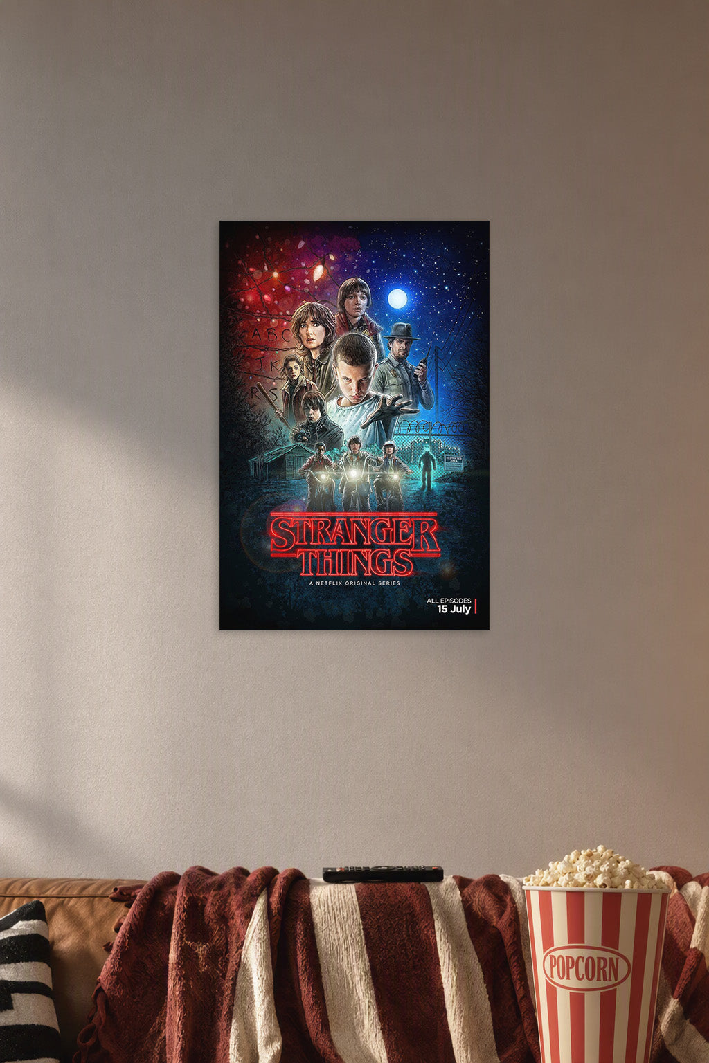 Stranger Things Cast in a cozy movie room above a brown sofa with popcorn.