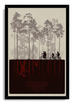 Stranger Things framed wall art print depicts bicycle riders in gray pines above a dark crimson Upside Down forest scene.