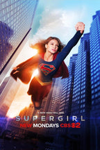 Supergirl poster featuring the caped hero flying above skyscrapers at sunrise, with Supergirl and CBS text below.