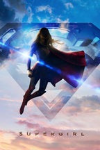 Supergirl wall art print features the heroine flying through blue and pink clouds before a giant S emblem, with a red cape and lens flare.