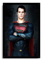Superman framed wall art print featuring Henry Cavill in a blue suit with crossed arms, red cape, and black border.