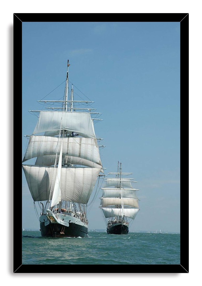 Tall ships framed wall art print features two traditional sailing ships with billowing white sails on blue water.