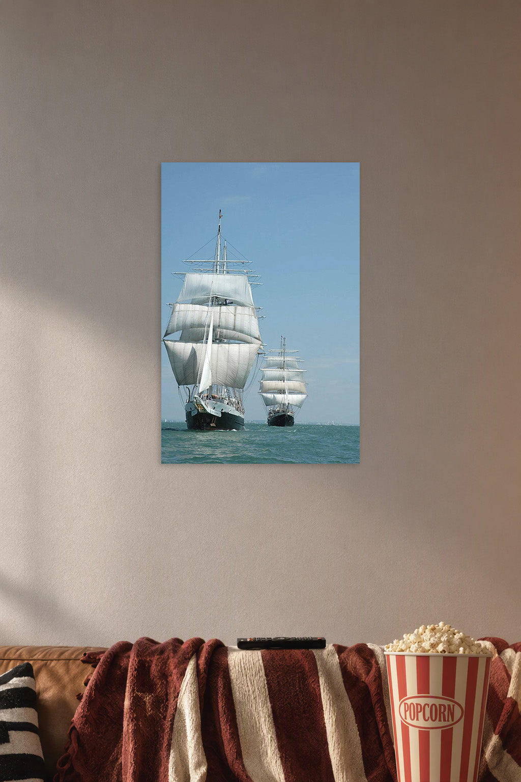 Tall Ships at Sea in a cozy movie room above a brown sofa with popcorn.