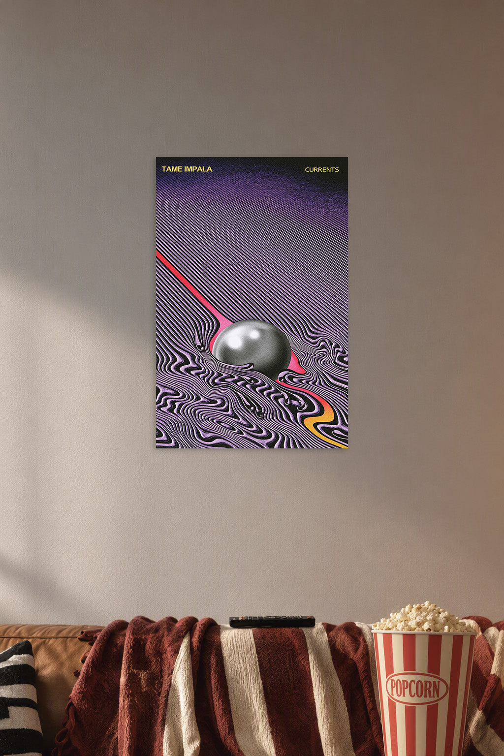 Tame Impala Currents Album Cover Art in a cozy movie room above a brown sofa with popcorn.