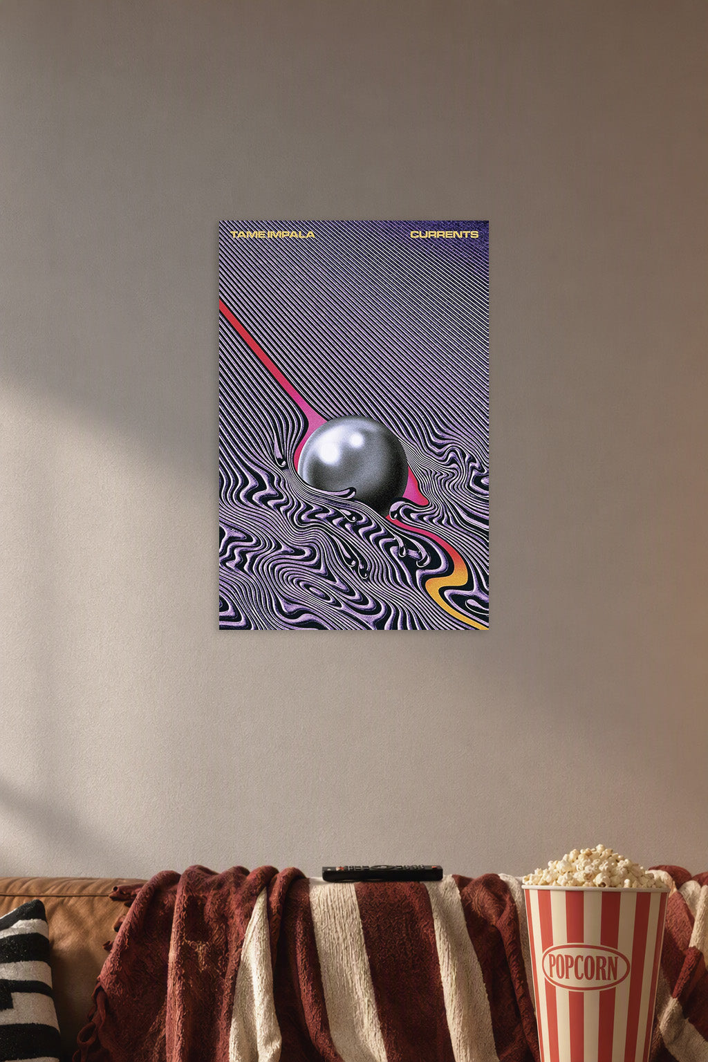 Tame Impala Music Poster in a cozy movie room above a brown sofa with popcorn.