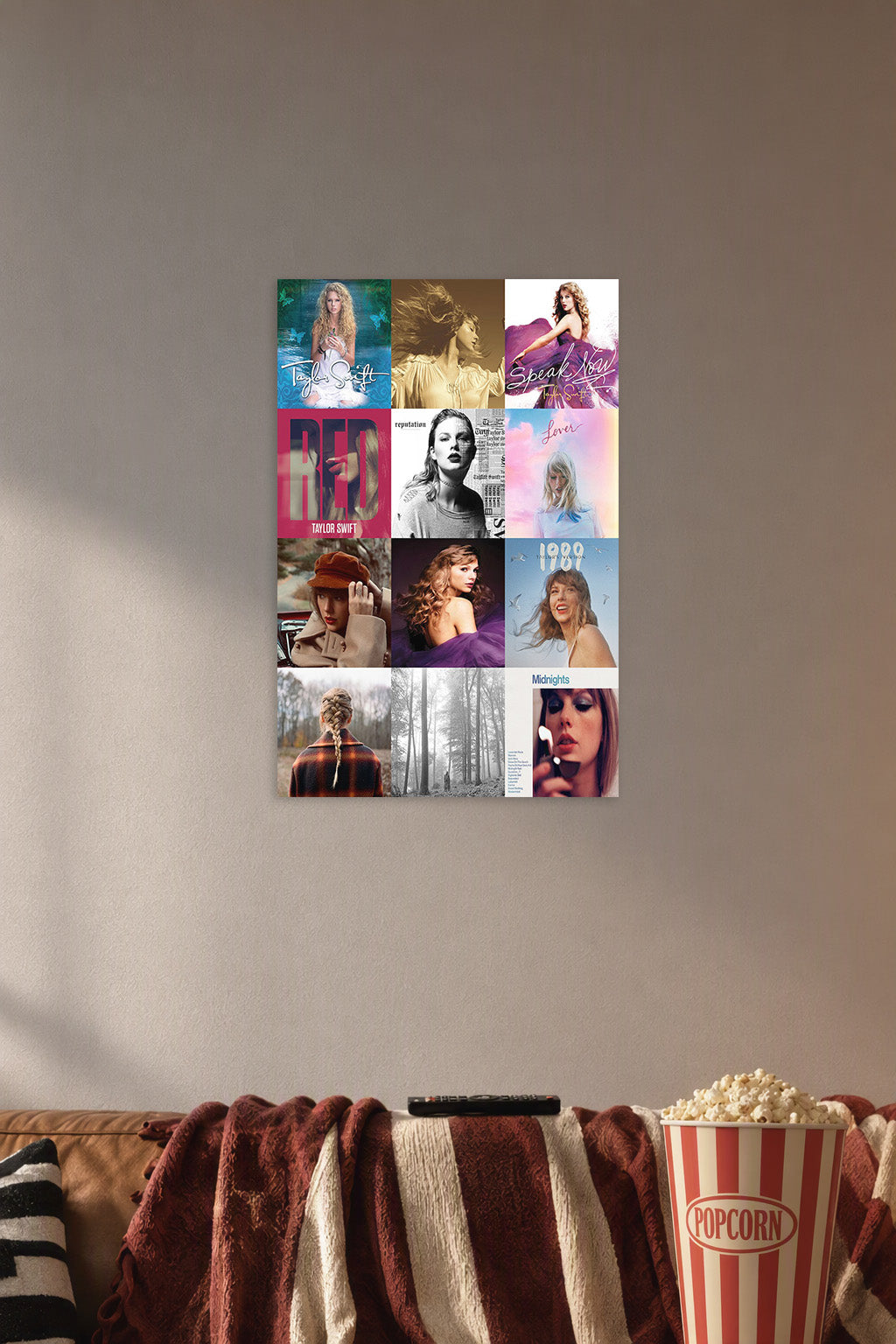 Taylor Swift Album Covers in a cozy movie room above a brown sofa with popcorn.