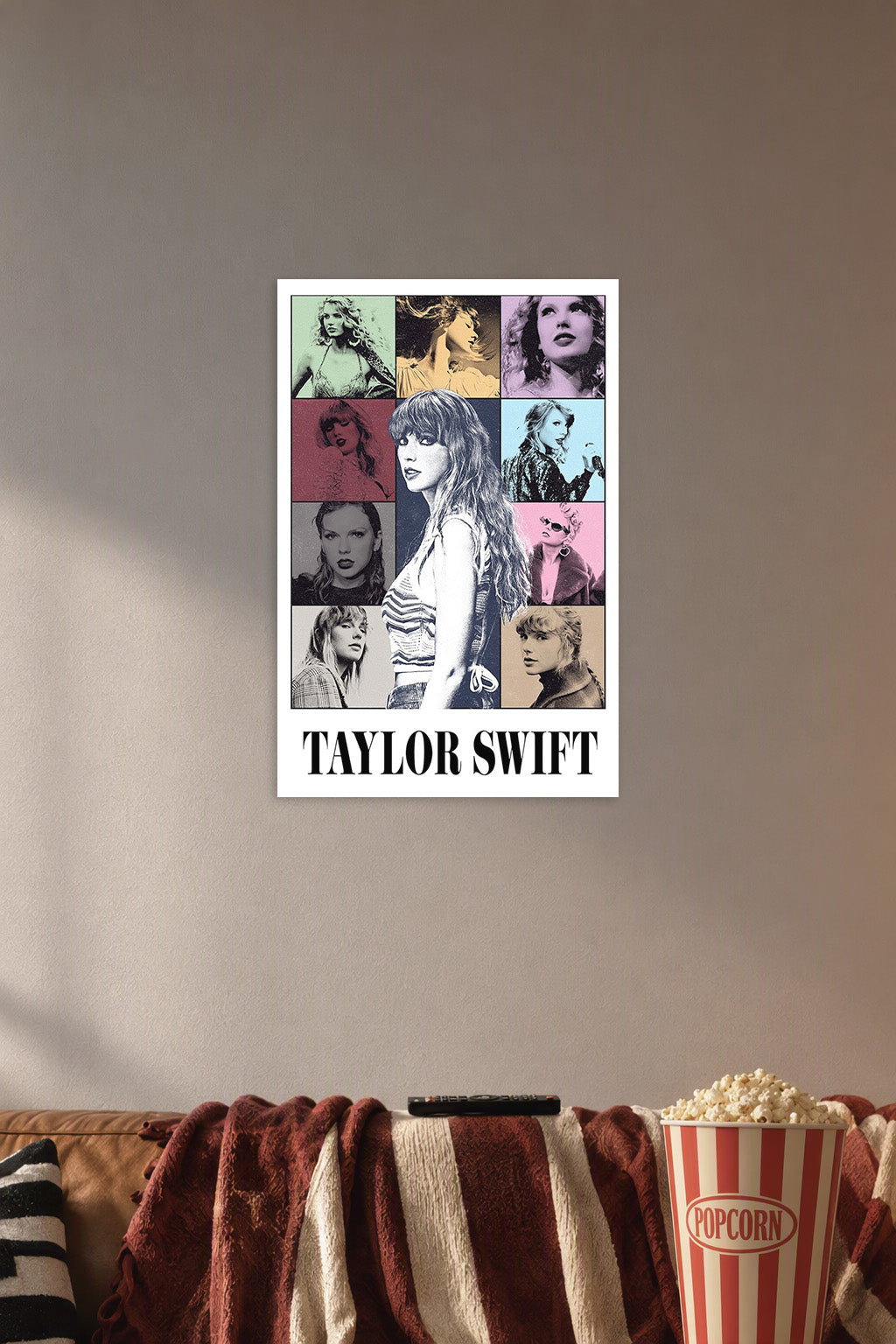 Taylor Swift Eras Pop Art in a cozy movie room above a brown sofa with popcorn.