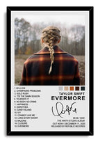 Taylor Swift Evermore framed wall art print with a black border, braided back-view portrait, woodland background, track list, and album text.