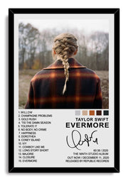 Taylor Swift Evermore framed wall art print with a black border, braided back-view portrait, woodland background, track list, and album text.