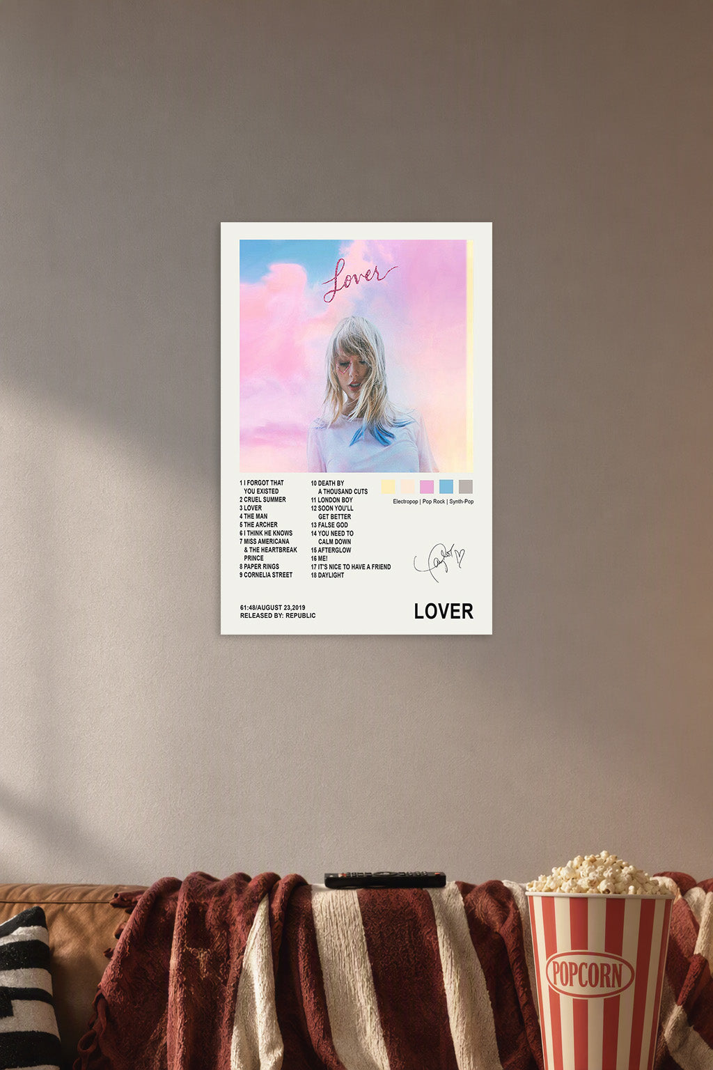 Taylor Swift Lover Album in a cozy movie room above a brown sofa with popcorn.
