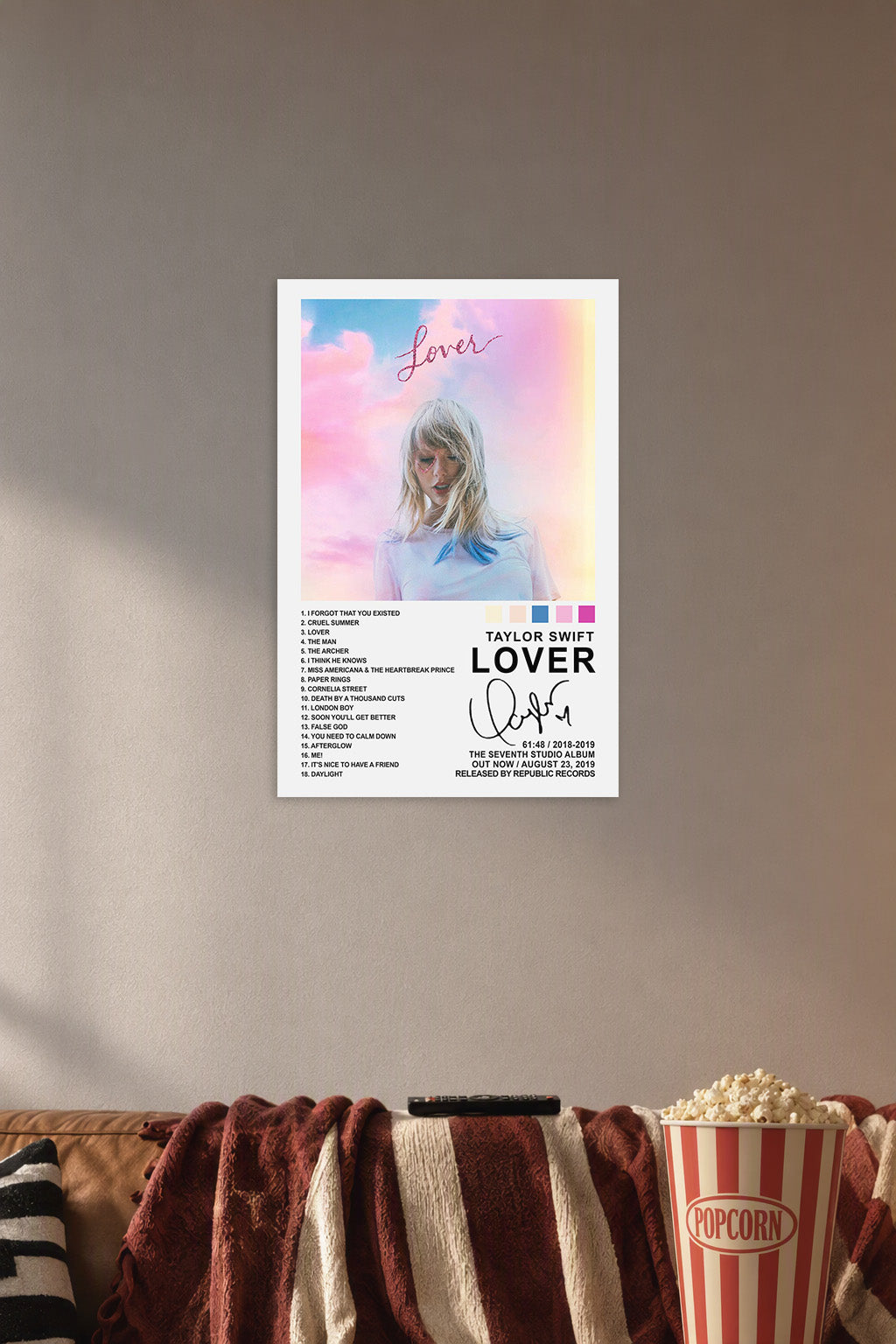 Taylor Swift Lover Album in a cozy movie room above a brown sofa with popcorn.