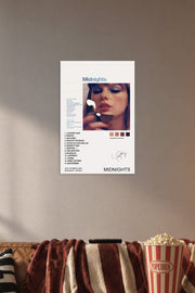 Taylor Swift Midnights Album in a cozy movie room above a brown sofa with popcorn.
