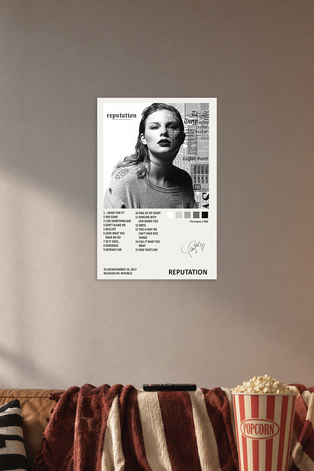 Taylor Swift Reputation Album in a cozy movie room above a brown sofa with popcorn.