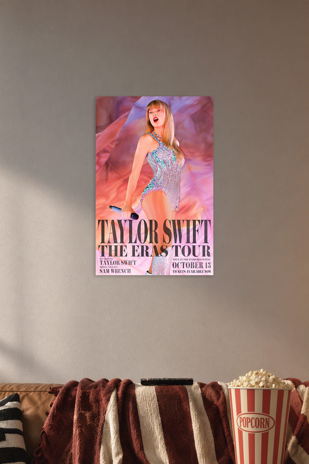 Taylor Swift The Eras Tour in a cozy movie room above a brown sofa with popcorn.