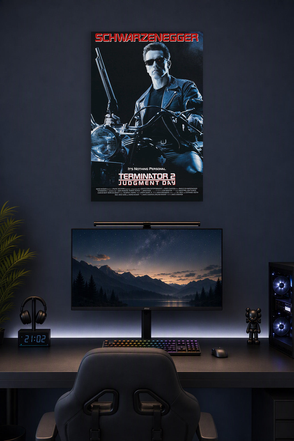 Terminator 2 Arnold Schwarzenegger in a gaming desk setup above a monitor.