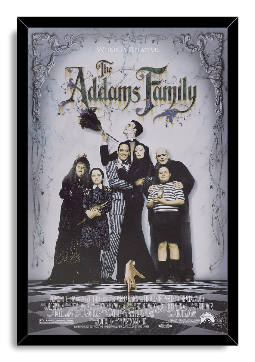 The Addams Family framed wall art print presents the family ensemble under ornate cobwebs in a black frame with a white marble background.