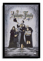 The Addams Family framed wall art print presents the family ensemble under ornate cobwebs in a black frame with a white marble background.