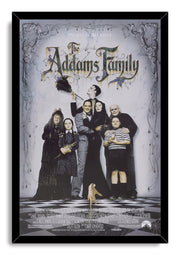 The Addams Family framed wall art print presents the family ensemble under ornate cobwebs in a black frame with a white marble background.