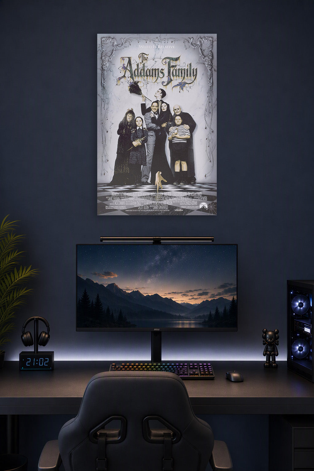 The Addams Family in a gaming desk setup above a monitor.