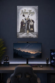 The Addams Family in a gaming desk setup above a monitor.
