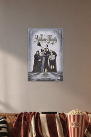 The Addams Family in a cozy movie room above a brown sofa with popcorn.