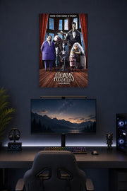 The Addams Family Halloween in a gaming desk setup above a monitor.