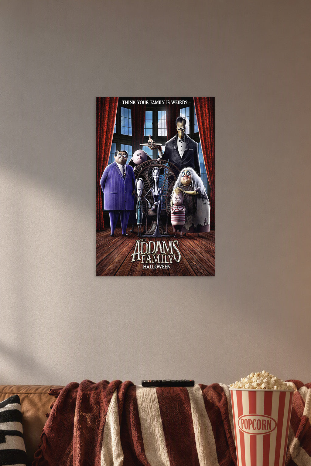 The Addams Family Halloween in a cozy movie room above a brown sofa with popcorn.
