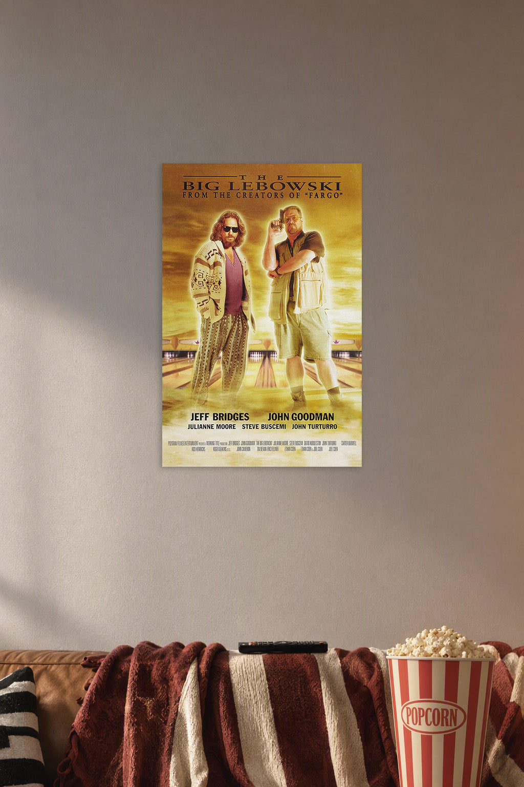 The Big Lebowski Movie Poster in a cozy movie room above a brown sofa with popcorn.