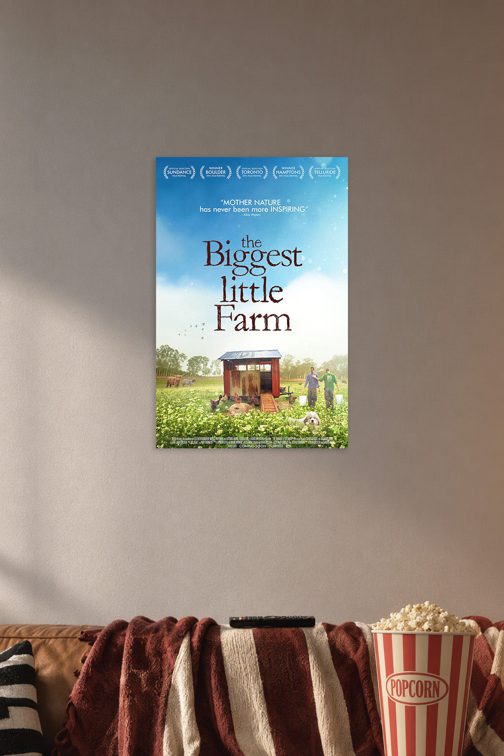 The Biggest Little Farm in a cozy movie room above a brown sofa with popcorn.