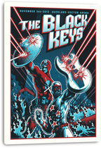 The Black Keys wall art print on canvas features superhero band figures battling lasers beneath bold blue and white lettering.