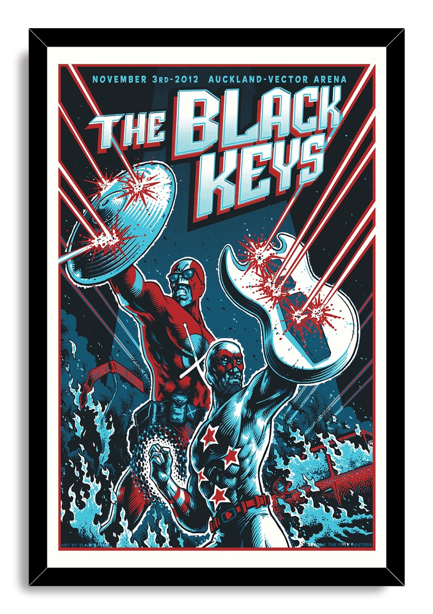 Framed The Black Keys poster presents two costumed heroes, a raised shield, a white guitar, and red laser beams.