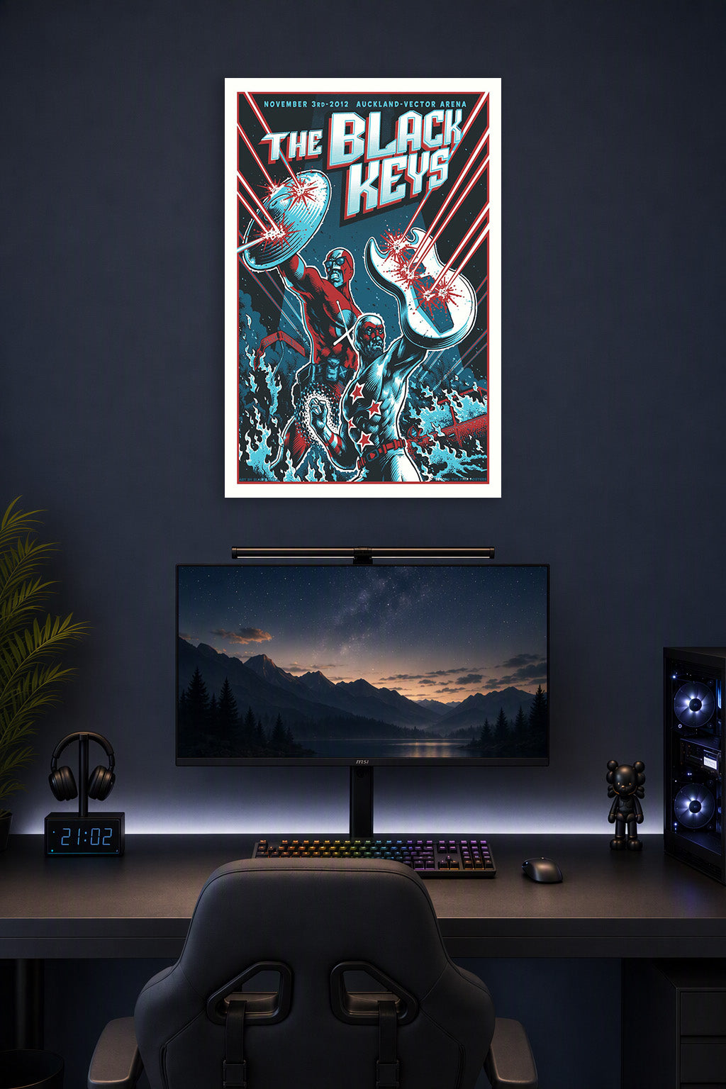 The Black Keys Superhero Duo in a gaming desk setup above a monitor.