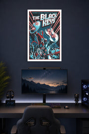 The Black Keys Superhero Duo in a gaming desk setup above a monitor.