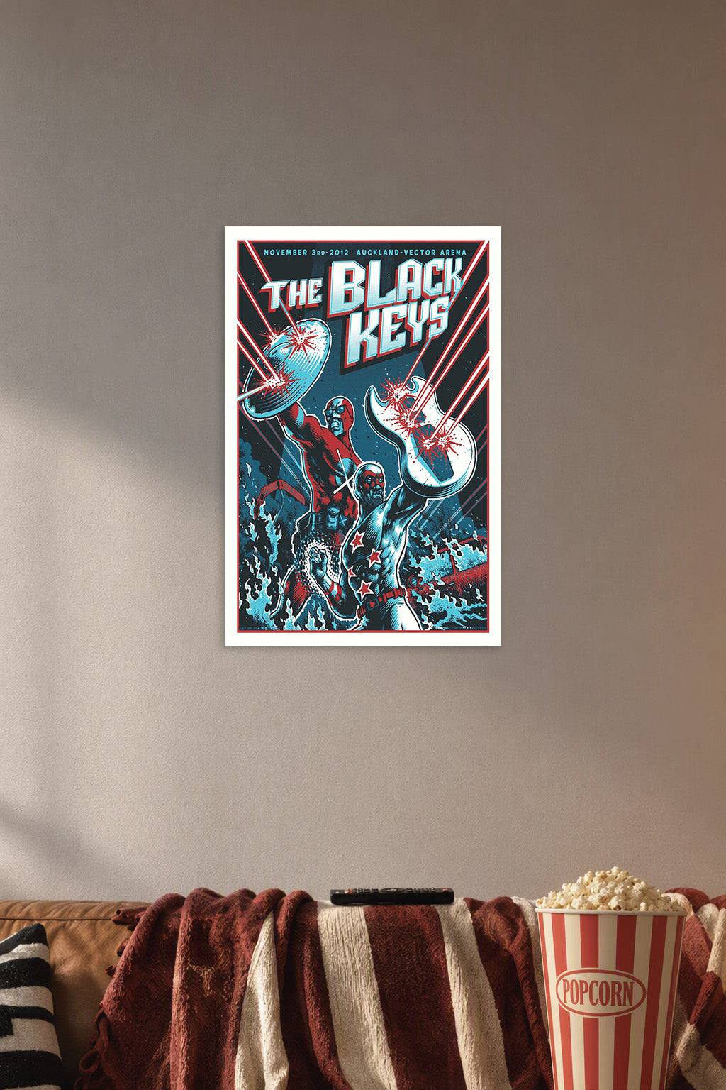 The Black Keys Superhero Duo in a cozy movie room above a brown sofa with popcorn.