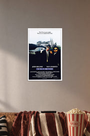 The Blues Brothers in a cozy movie room above a brown sofa with popcorn.