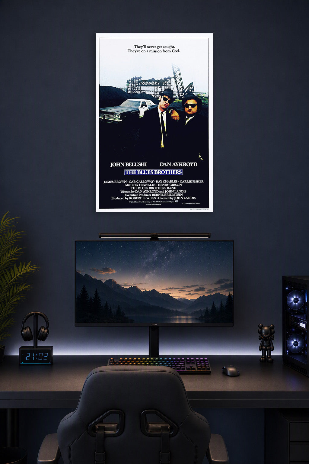The Blues Brothers in a gaming desk setup above a monitor.