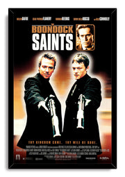 The Boondock Saints framed wall art print features two men aiming guns, a sepia headshot, and a black mitered frame.