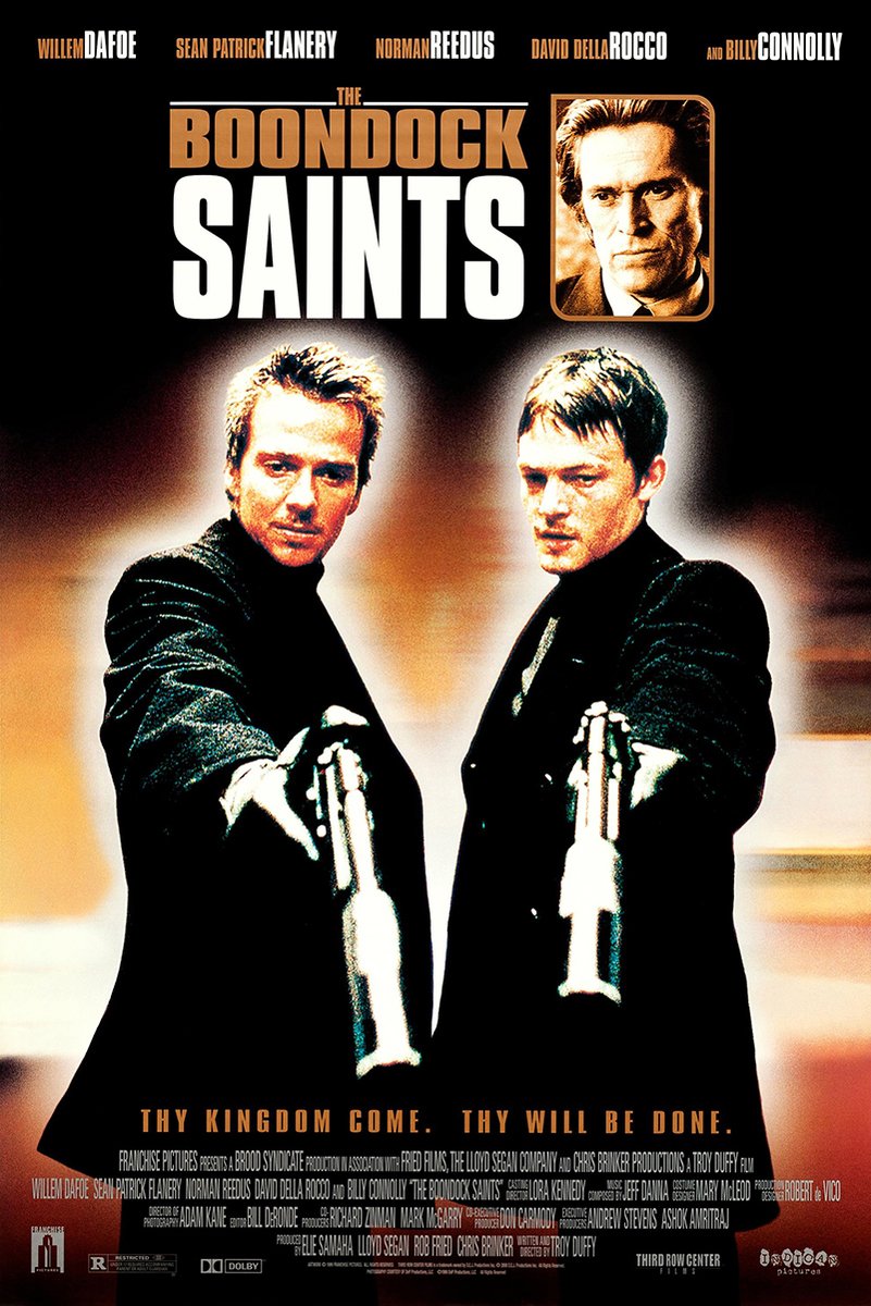 The Boondock Saints poster features two men in black coats aiming guns beneath bold white and copper title text.