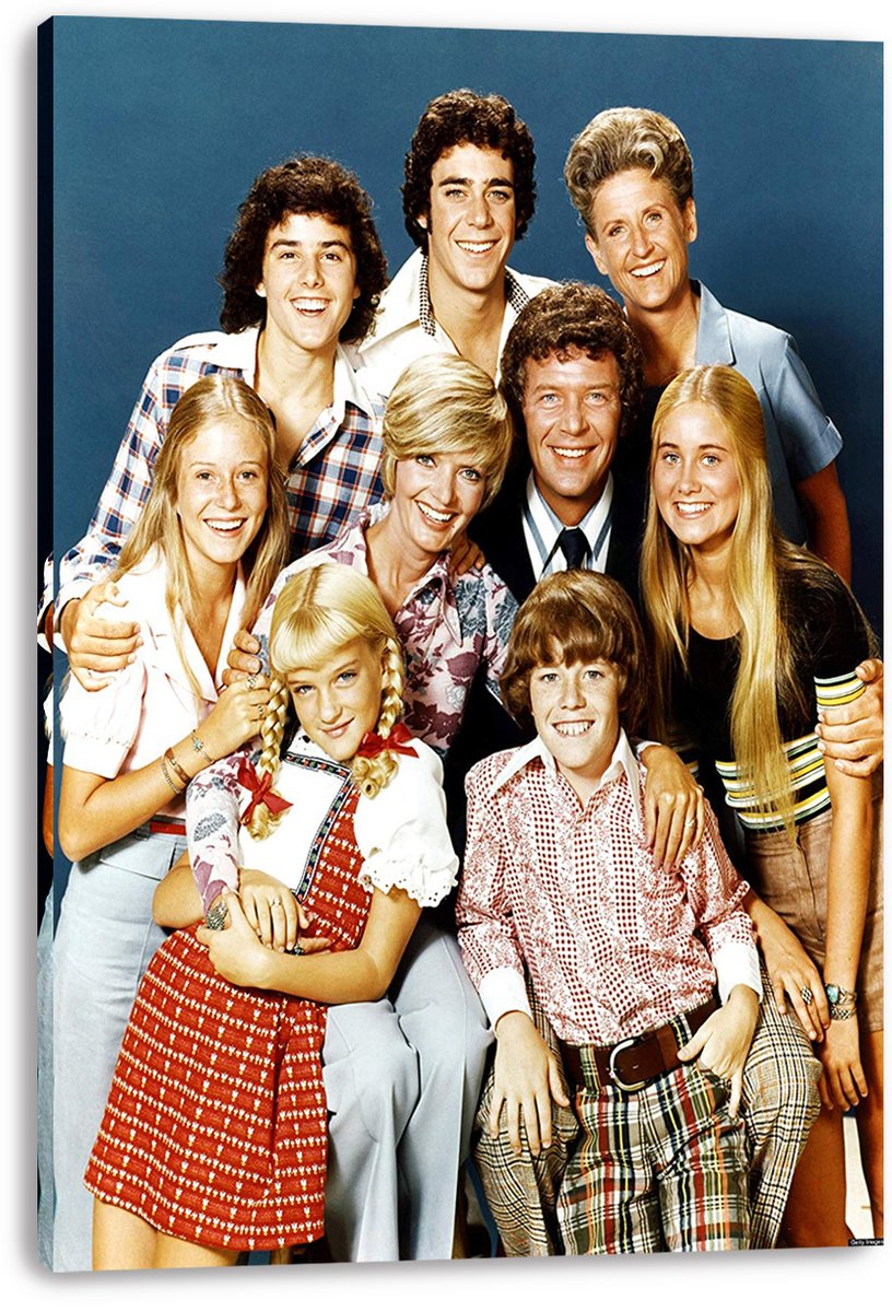 The Brady Bunch cast canvas wall art print presents nine smiling actors in a close family portrait against a deep blue background.