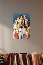 The Brady Bunch Cast in a cozy movie room above a brown sofa with popcorn.