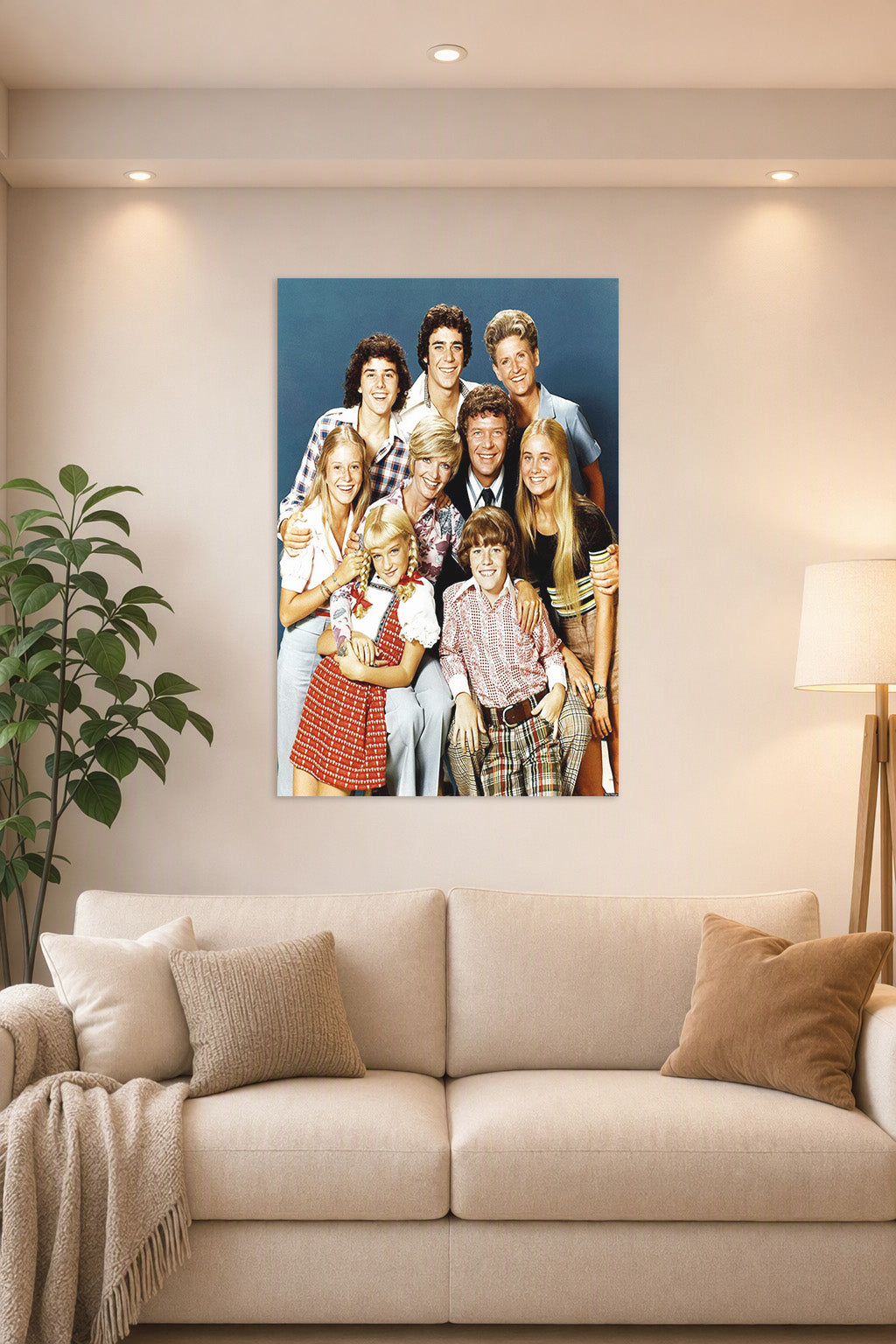 The Brady Bunch Cast in a bright living room above a beige sofa.