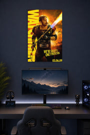 The Comedian from Watchmen in a gaming desk setup above a monitor.