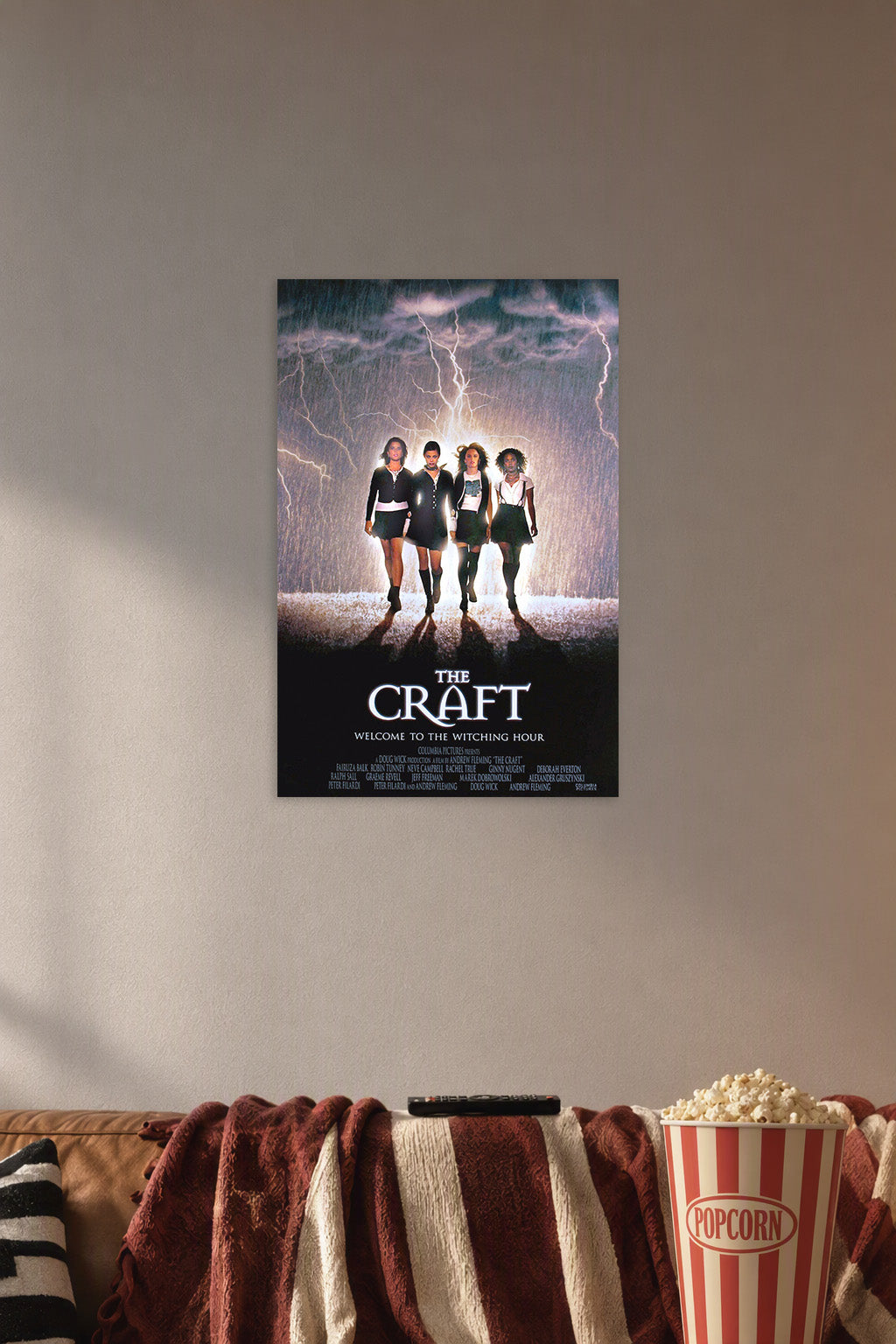 The Craft Movies in a cozy movie room above a brown sofa with popcorn.