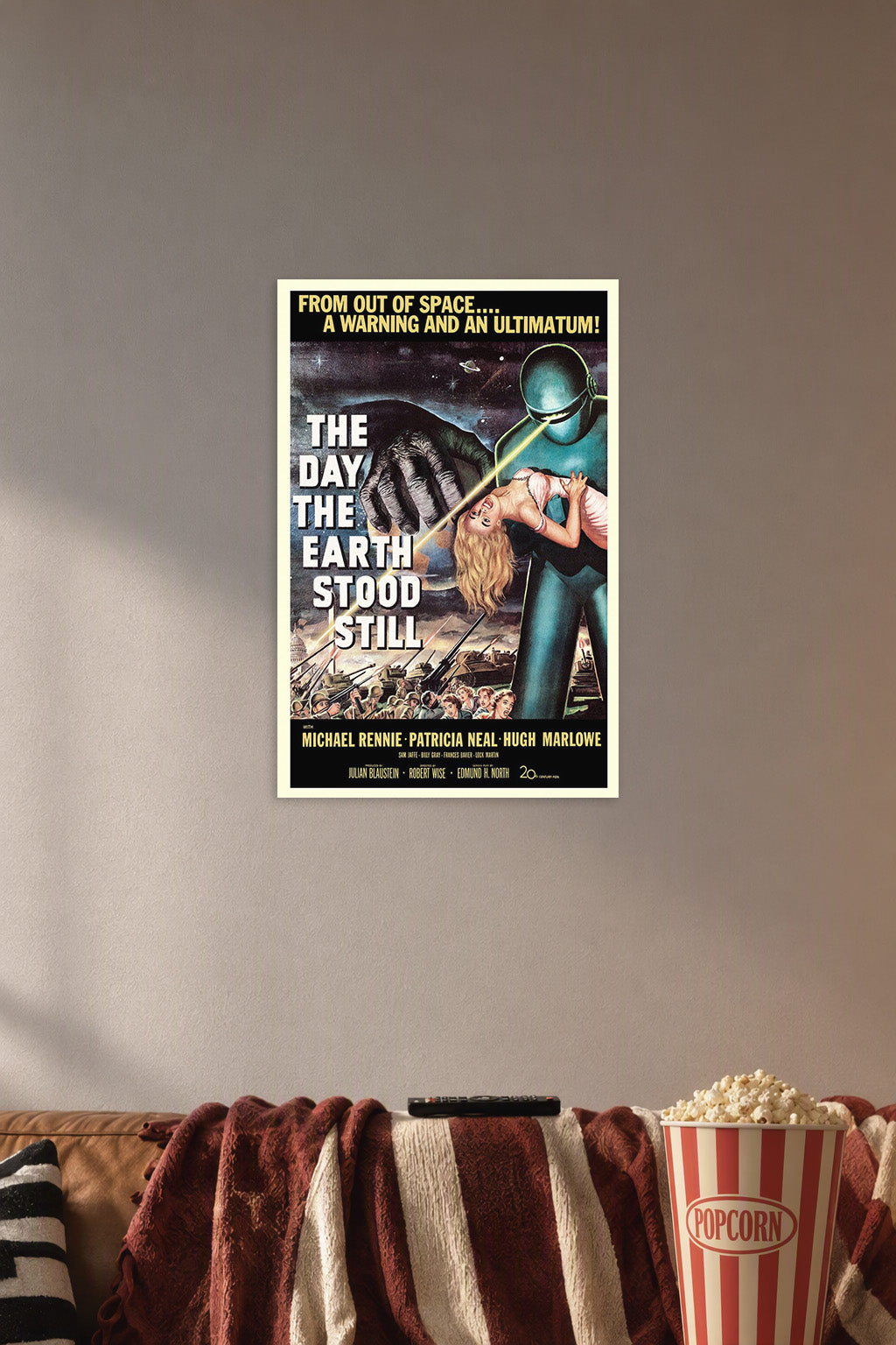 The Day the Earth Stood Still Movie Poster in a cozy movie room above a brown sofa with popcorn.